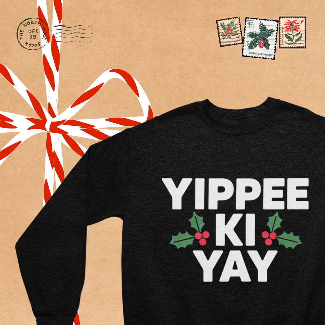 Close-up of the playful graphic on the Yippi Ki Yay Crew Neck sweatshirt, featuring vibrant lettering