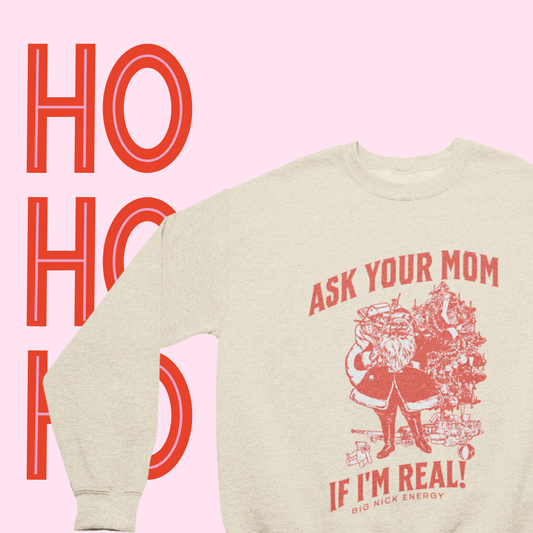 Close-up of the whimsical graphic on the Ask Your Mom If I'm Real Santa Crew Neck sweatshirt, featuring playful lettering."