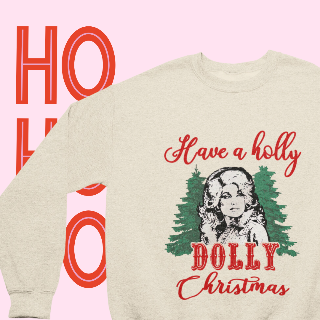 Close-up of the 'Have a Holly Dolly Christmas' text on a soft crewneck sweatshirt."