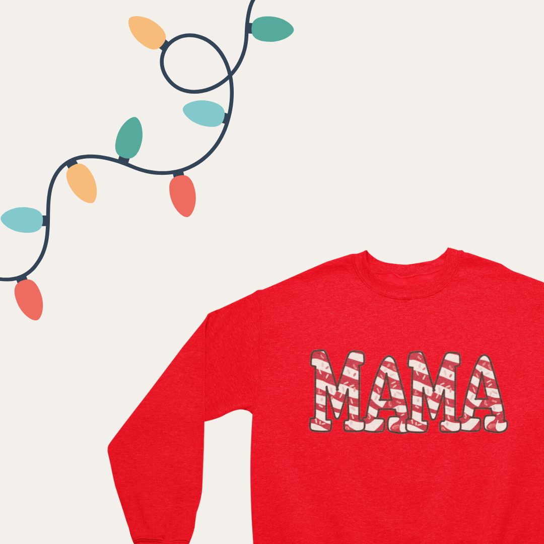 Close-up of the 'Christmas Tree Cake Mama' text on a cozy crewneck sweatshirt.