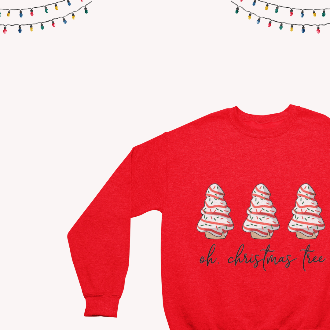 Close-up of the 'Christmas Cake, Oh Christmas Tree' text on a cozy crewneck sweatshirt."