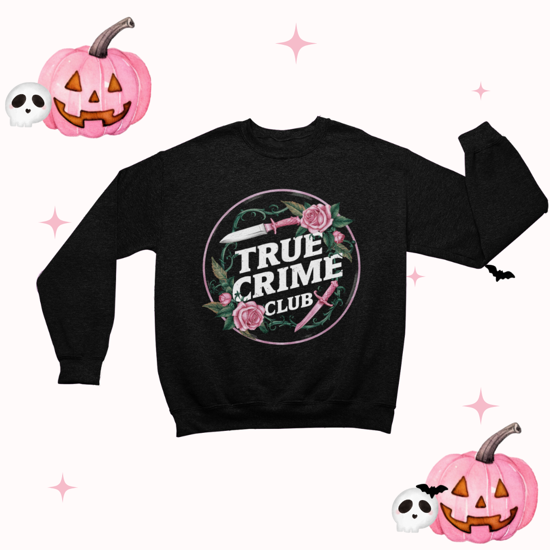 a black sweater with a pink rose on it and a jack - o - lantern