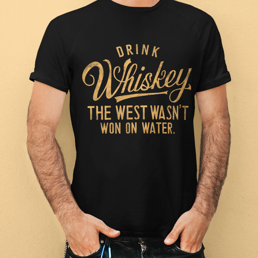 "Drink Whiskey Because the West Wasn't Won on Water T-Shirt - Black unisex cotton tee featuring a bold western quote, ideal for cowboy enthusiasts and western culture fans."