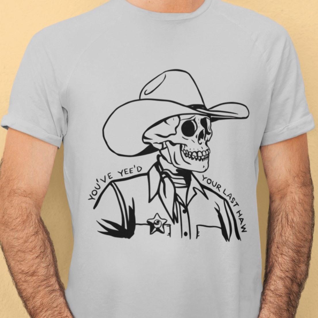 Skeleton cowboy with hat and boots, text 'You've Yee'd Your Last Haw' on a white t-shirt"